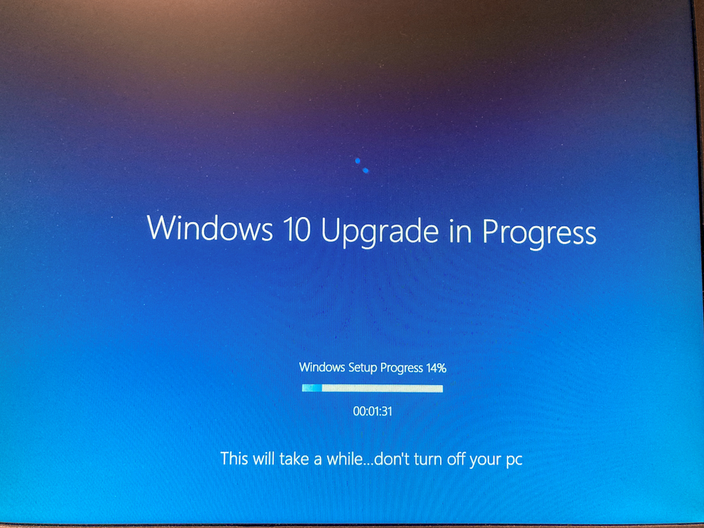 A blue screen with a Windows 10 update that has progressed 14%