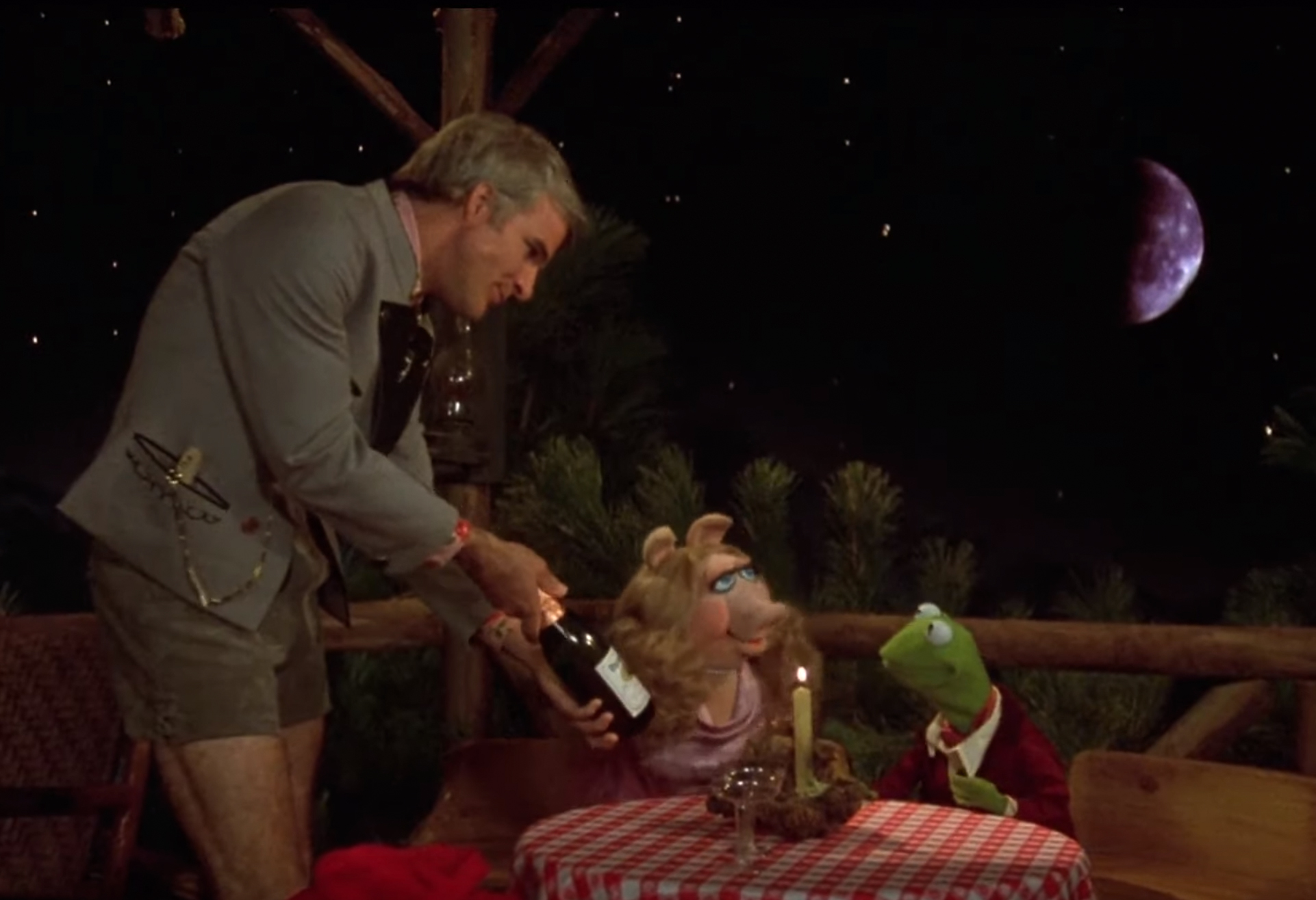 Steve Martin serving Kermit and Miss Piggy a bottle of 95 cents wine in The Muppet Movie